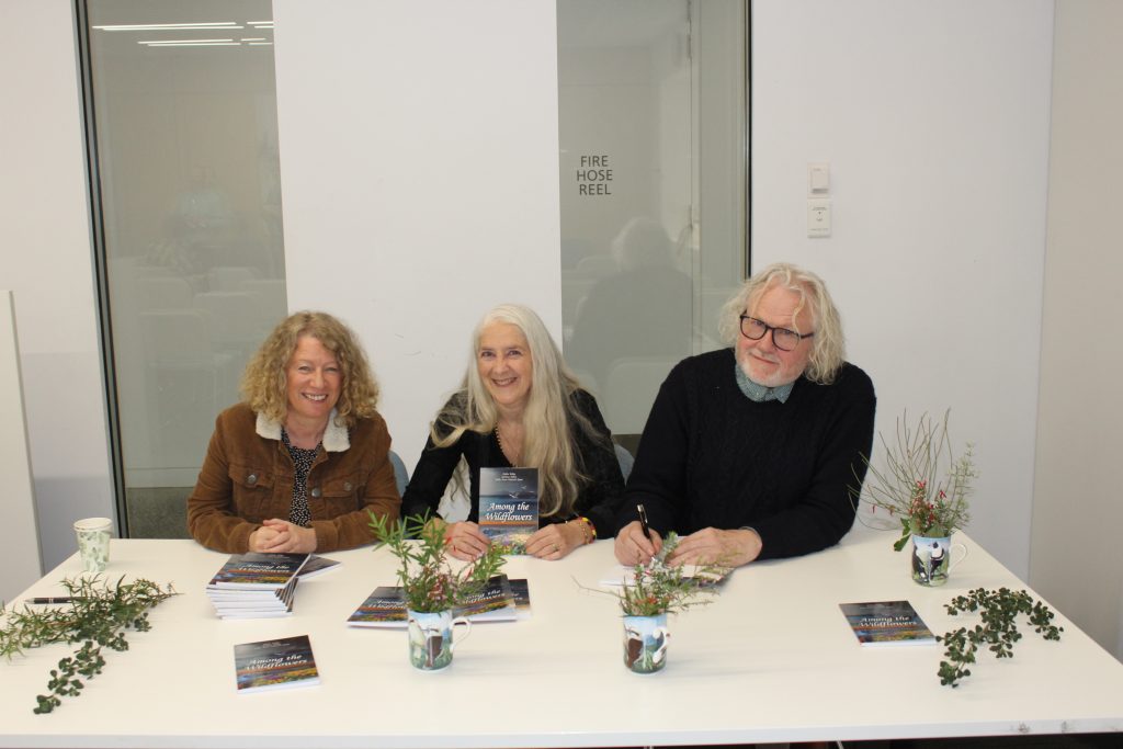 Delia, Sally-Anne and Seamus signing poetry books